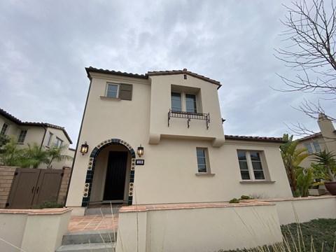 the front of the house with a gate and a door